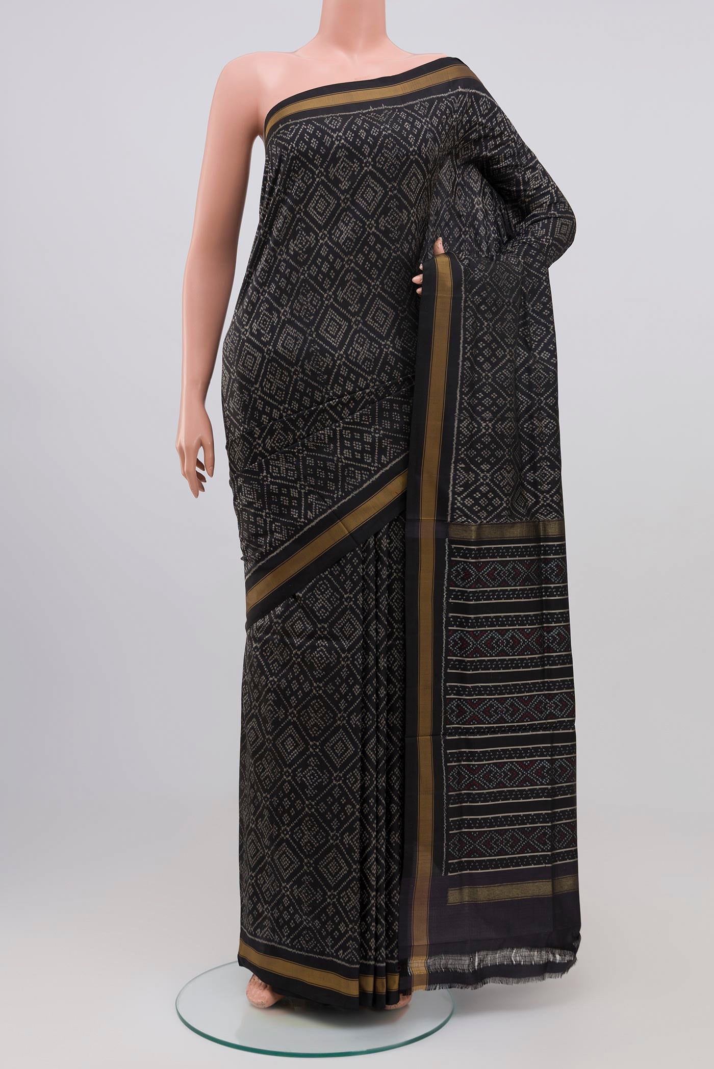 Black Pochampally Silk Saree with Ikat design on the body and Plain Border.  displayed on a mannequin