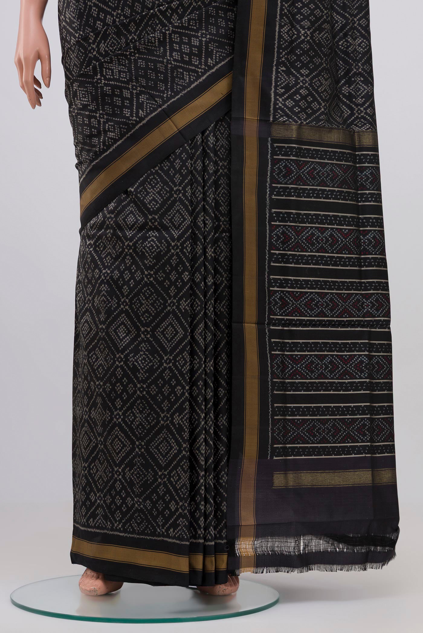 Pleats and pallu of Black Pochampally Silk Saree with Ikat design on the body and Plain Border. 