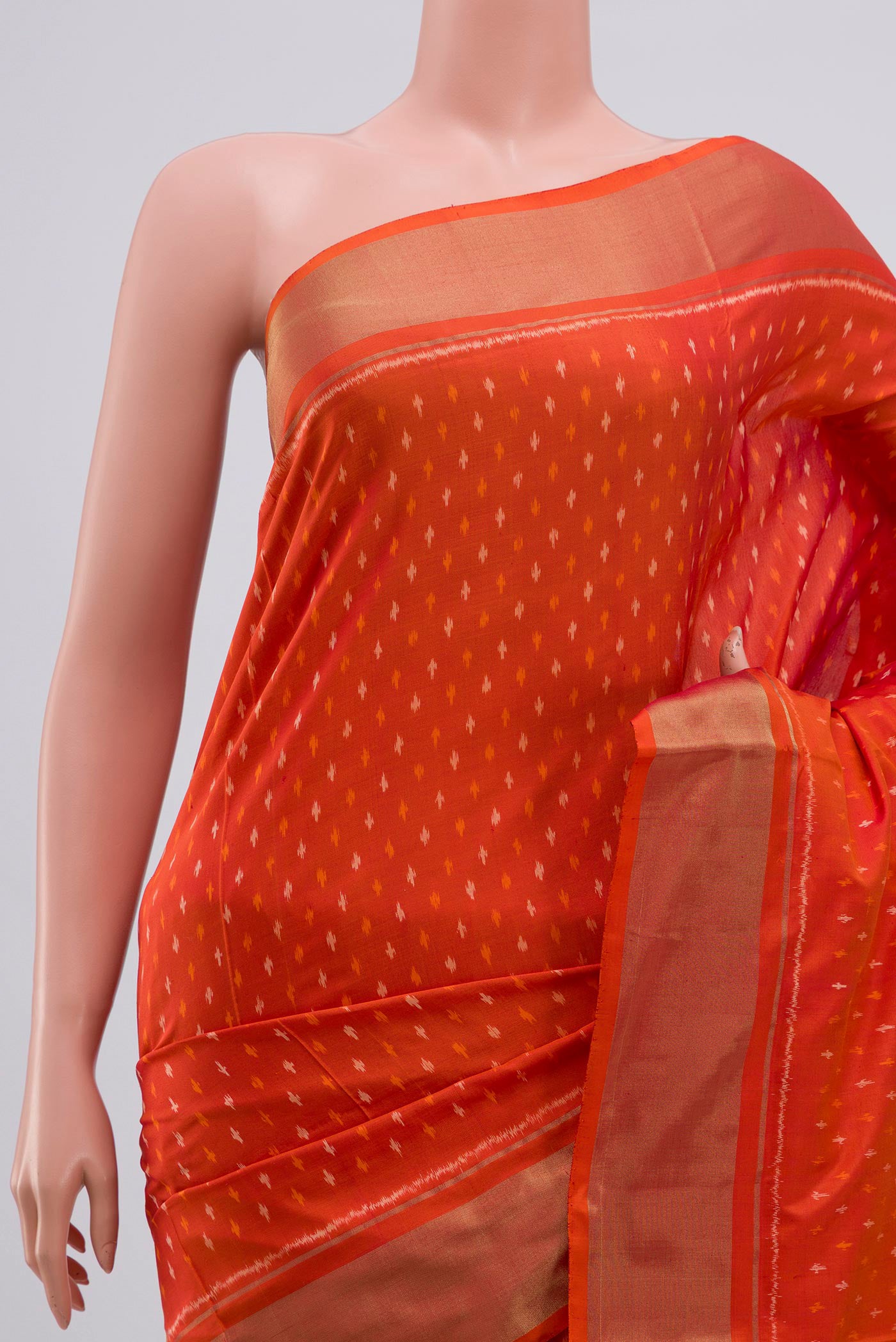 Border image of Orange Pochampally Silk Saree with Ikat design on the body and Zari Border. 