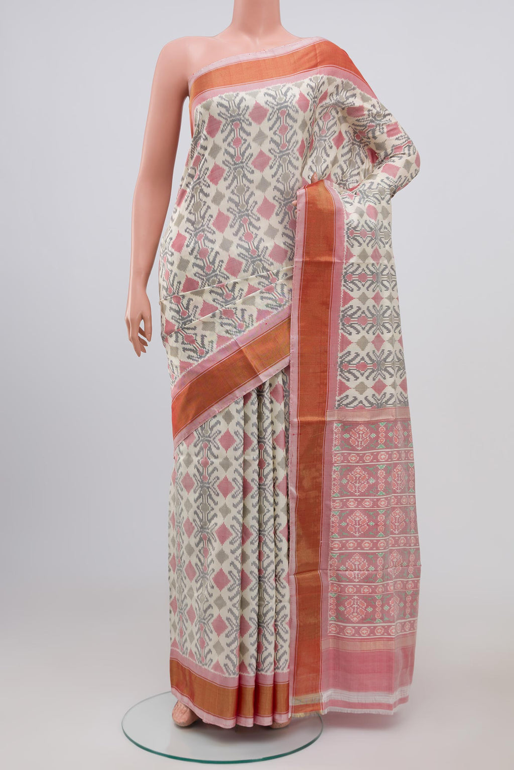 Cream Pochampally Silk Saree with Ikat design on the body and Zari Border.  displayed on a mannequin
