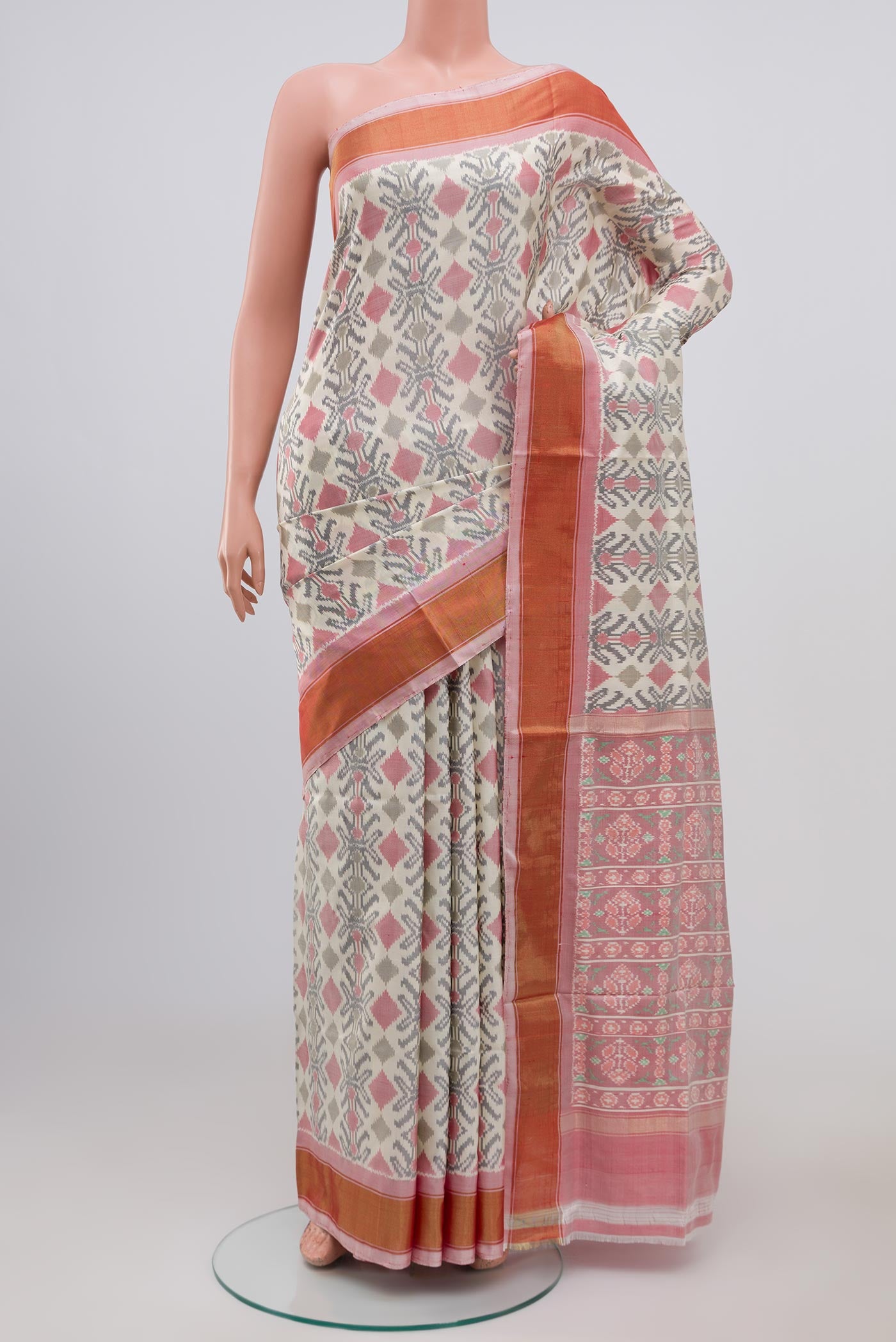 Cream Pochampally Silk Saree with Ikat design on the body and Zari Border.  displayed on a mannequin