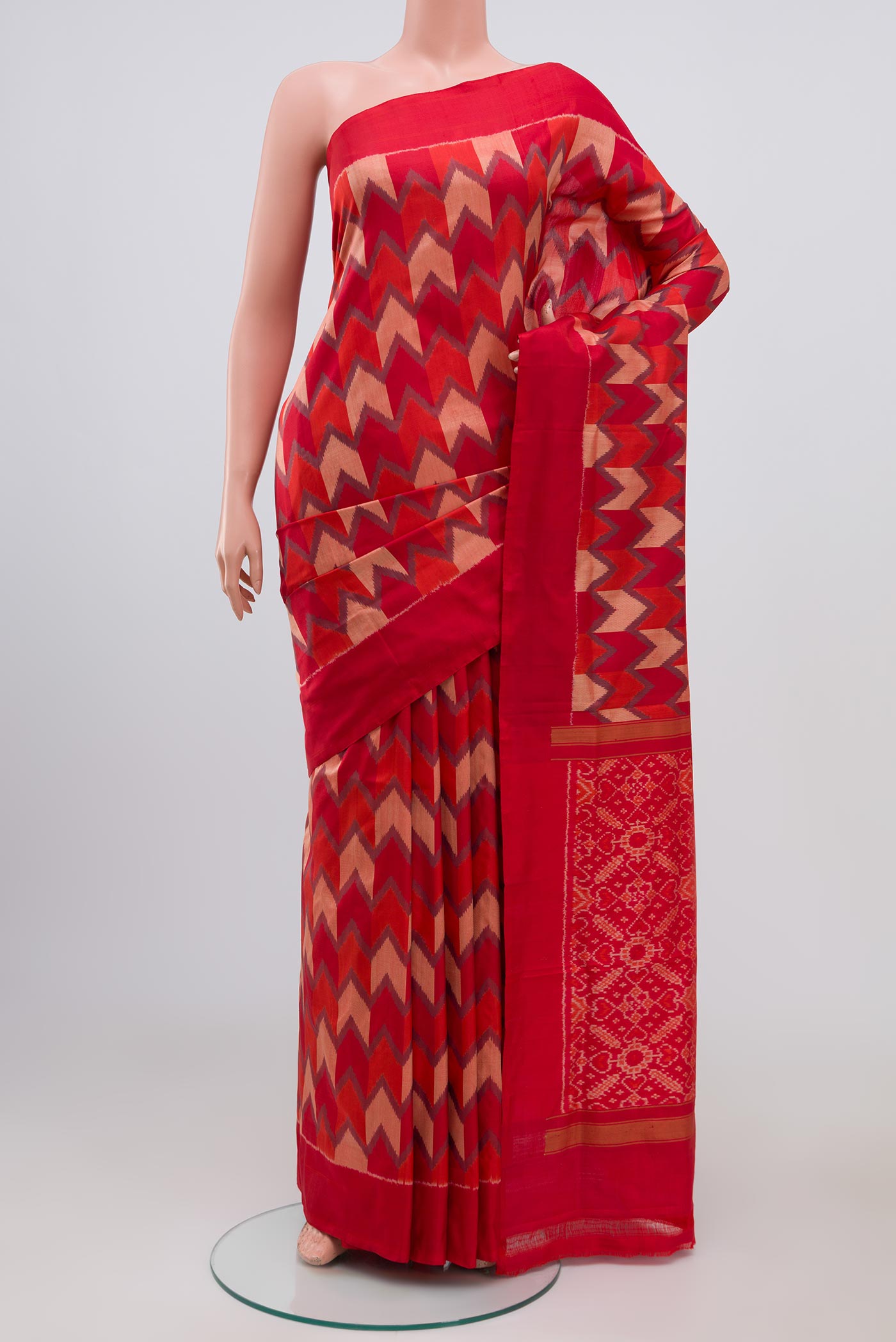 Red Pochampally Silk Saree with Ikat Print on the body and Plain Border.  displayed on a mannequin