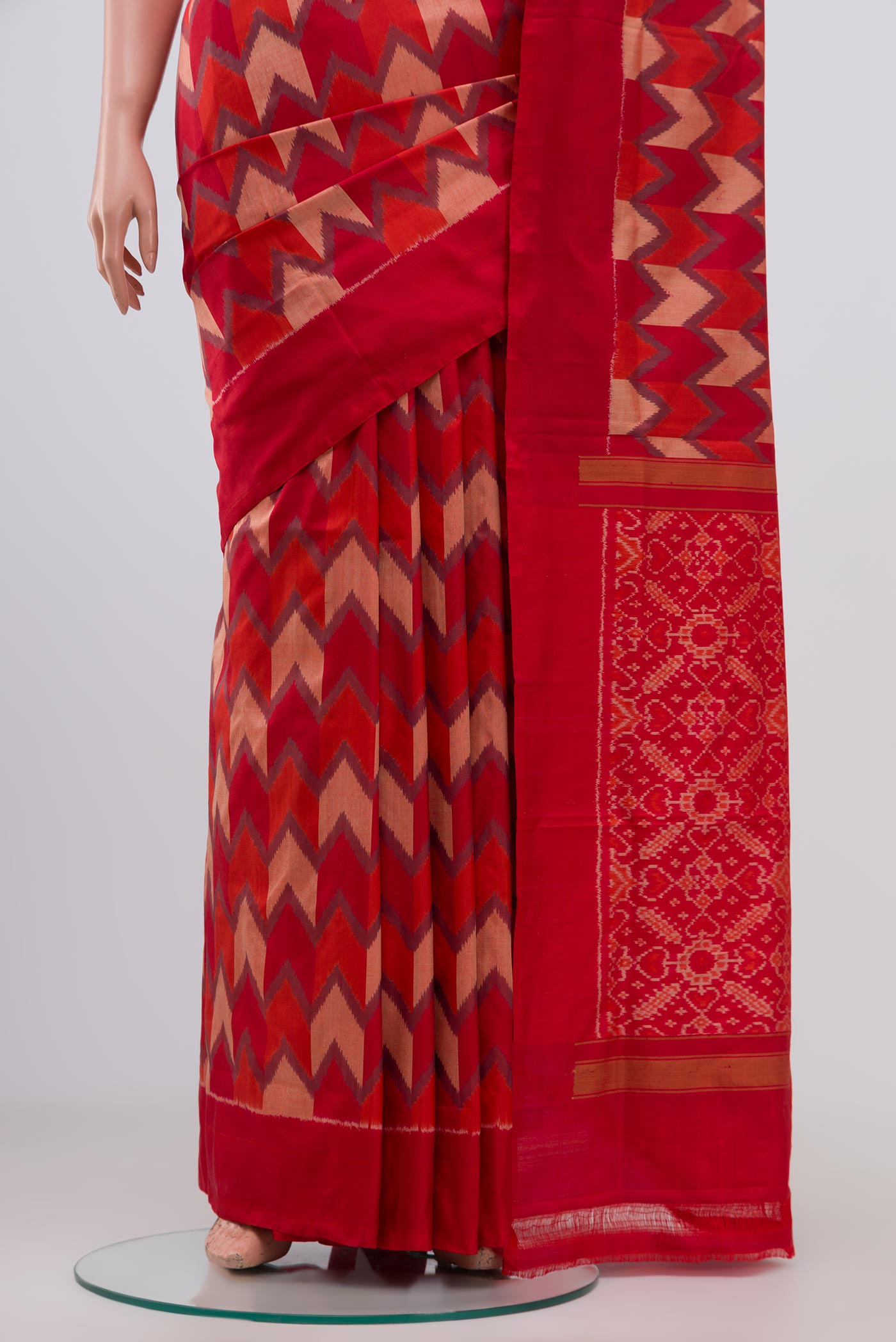 Pleats and pallu of Red Pochampally Silk Saree with Ikat Print on the body and Plain Border. 