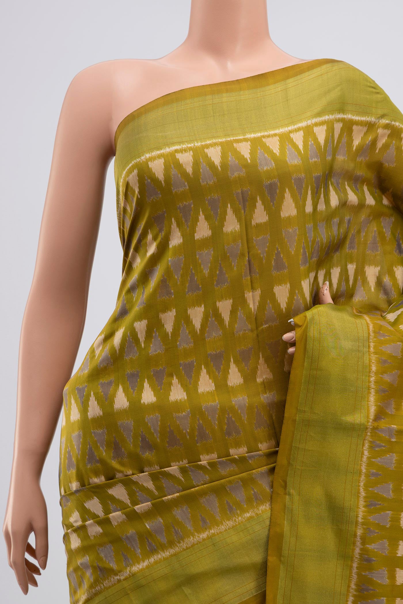 Border image of Green Pochampally Silk Saree with Ikat Print on the body and Zari Border. 
