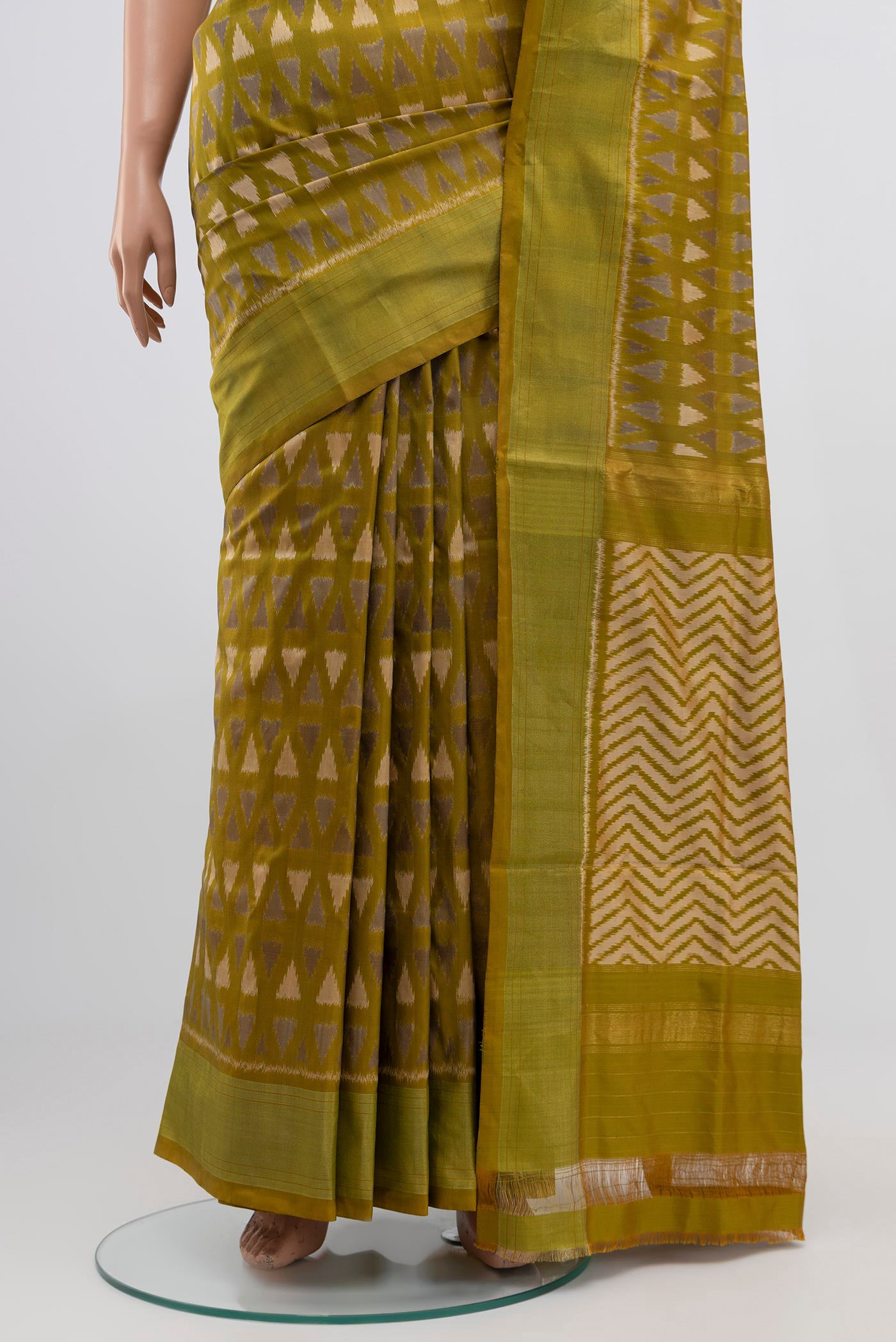 Pleats and pallu of Green Pochampally Silk Saree with Ikat Print on the body and Zari Border. 