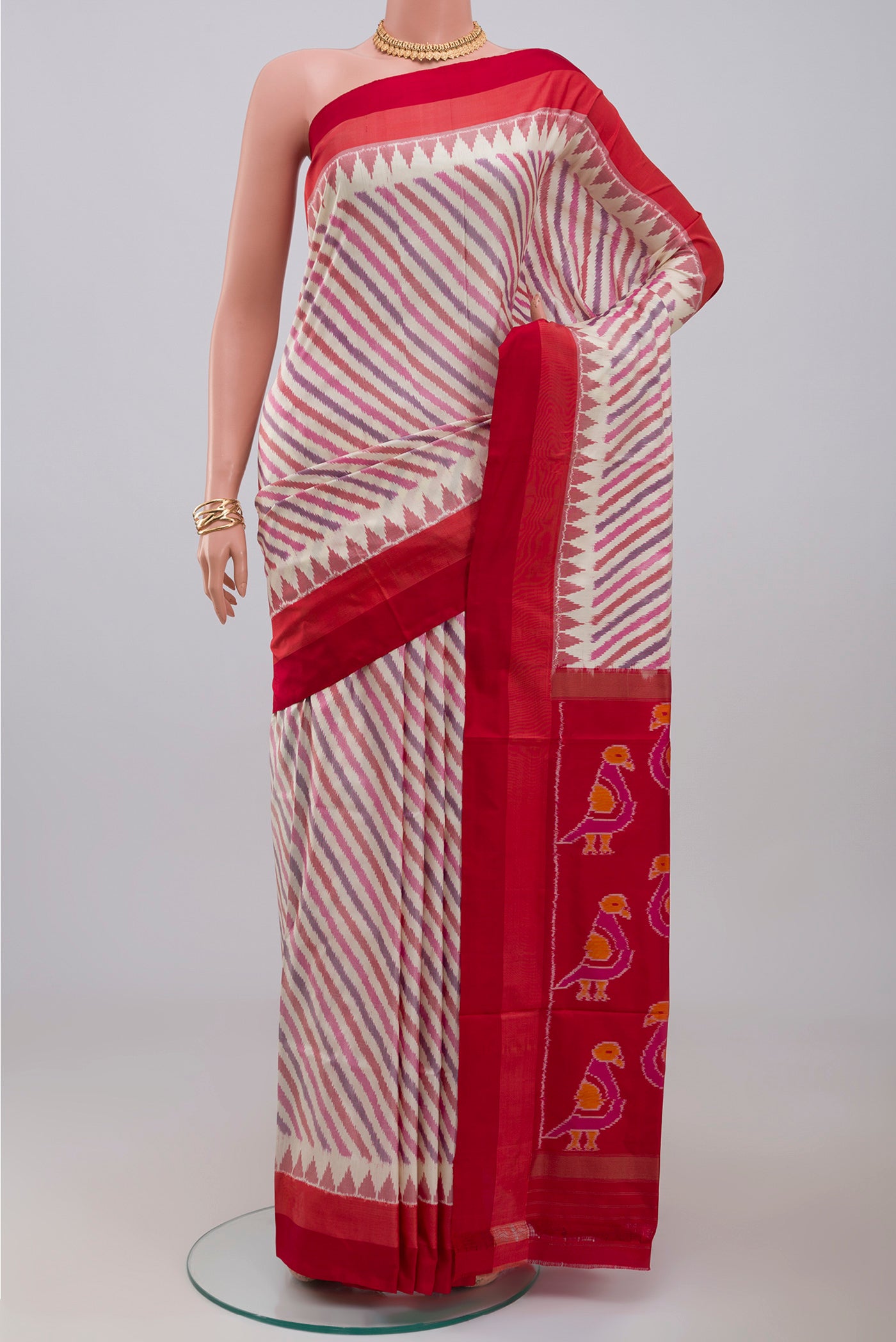 Cream Pochampally Silk Saree with Ikat design on the body and Plain Border.  displayed on a mannequin