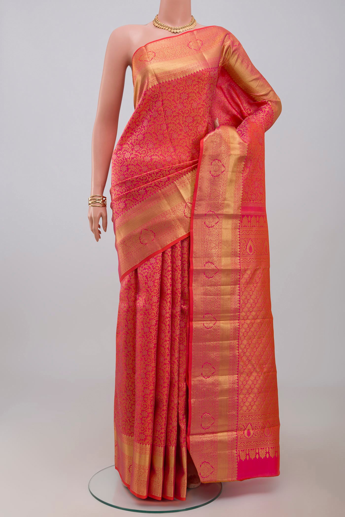Orange Kanjivaram Silk Saree with Zari Brocade on the body and Zari Border.  displayed on a mannequin