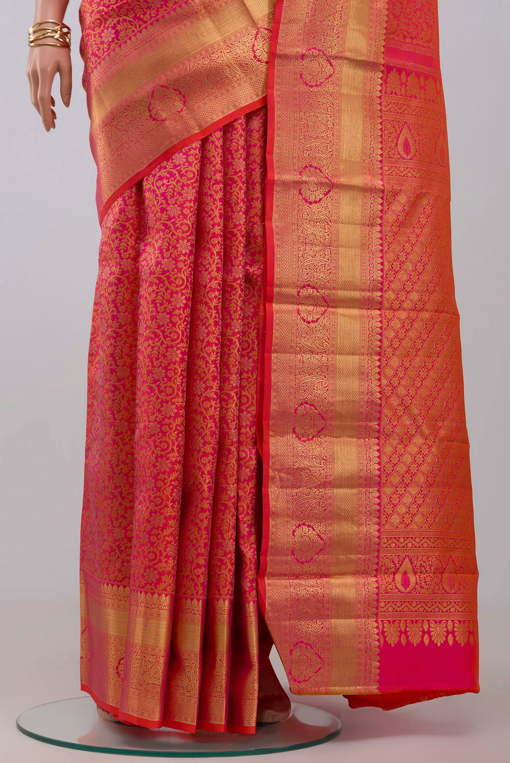 Pleats and pallu of Orange Kanjivaram Silk Saree with Zari Brocade on the body and Zari Border. 
