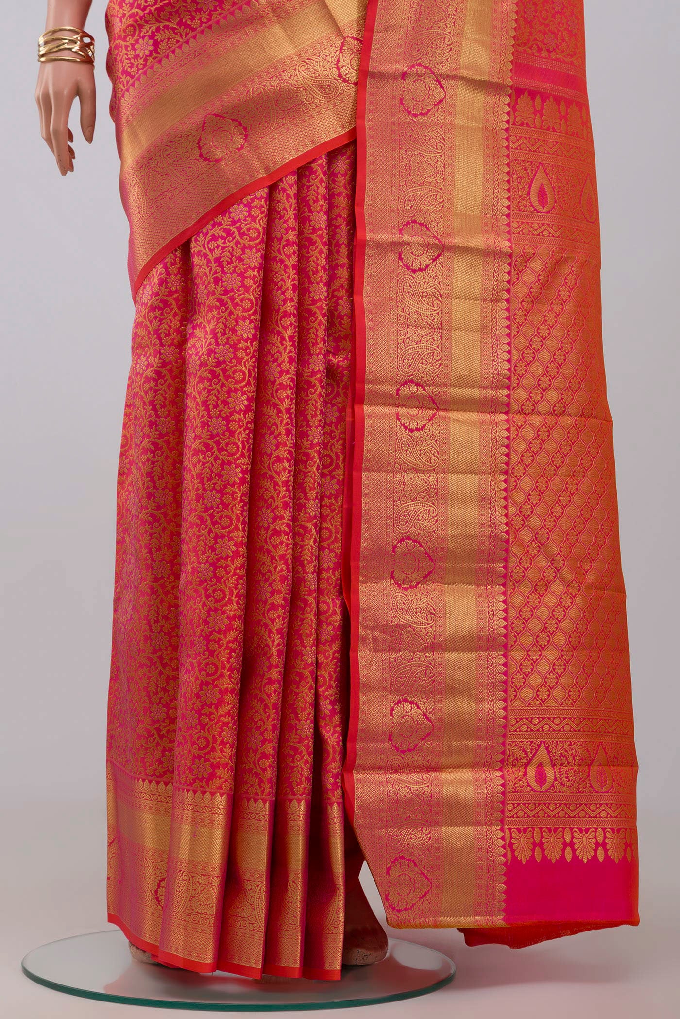 Pleats and pallu of Orange Kanjivaram Silk Saree with Zari Brocade on the body and Zari Border. 
