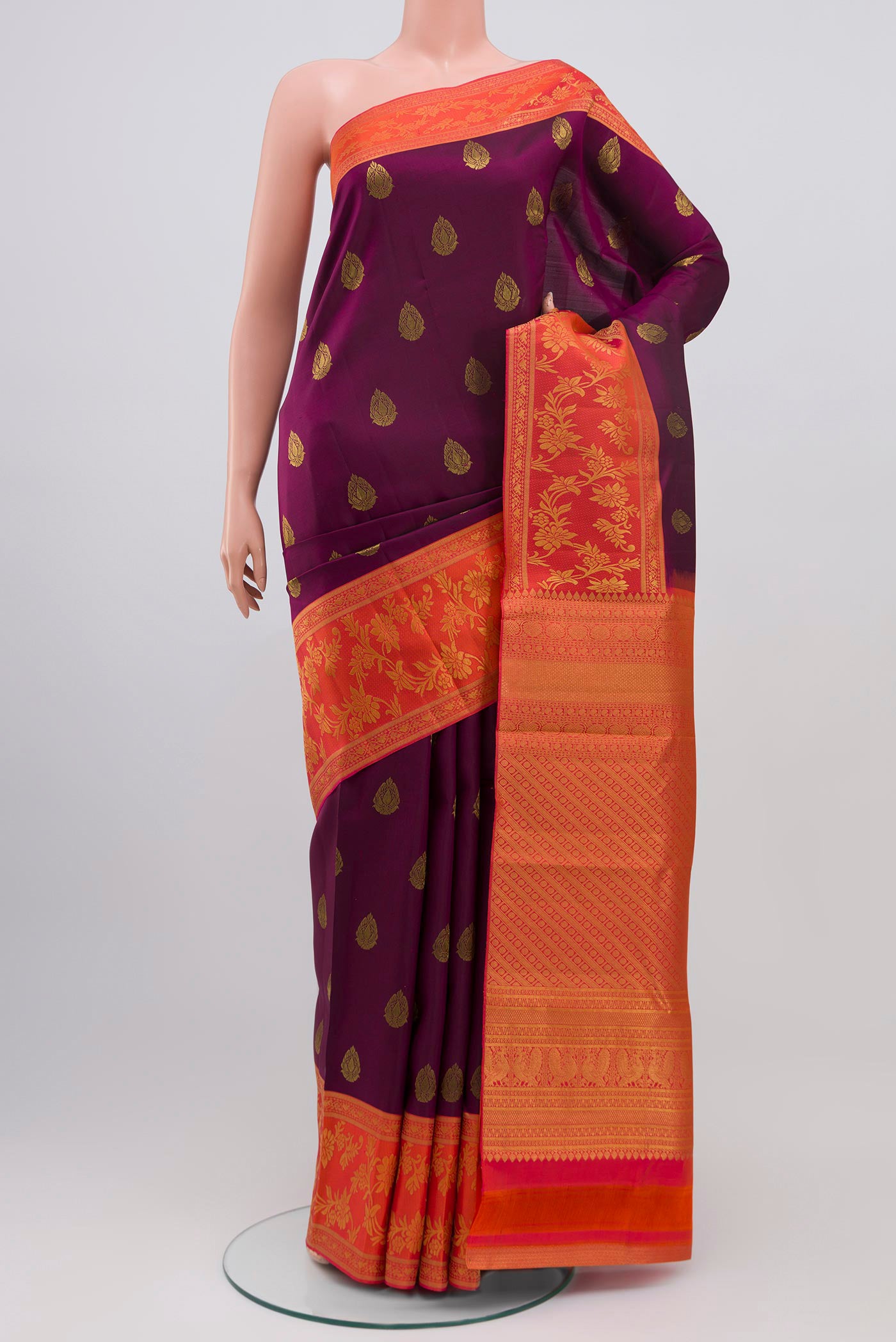 Purple Kanjivaram Saree with Zari Butta on the body and Fancy Border.  displayed on a mannequin
