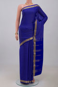 Blue Crepe Saree with Checked design on the body and Zari Border.  displayed on a mannequin