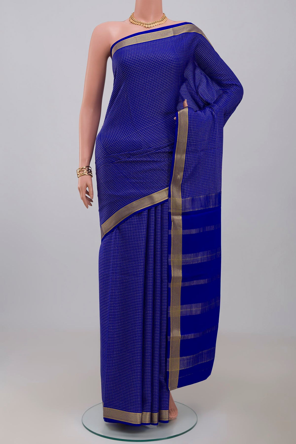 Blue Crepe Saree with Checked design on the body and Zari Border.  displayed on a mannequin
