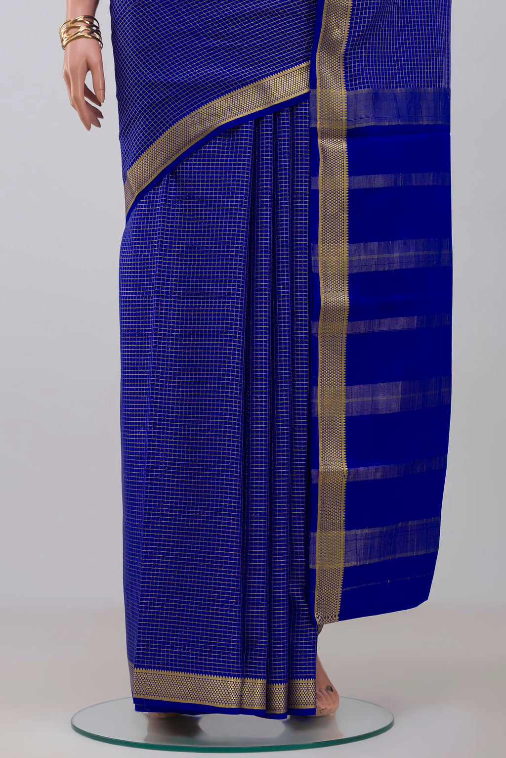 Pleats and pallu of Blue Crepe Saree with Checked design on the body and Zari Border. 