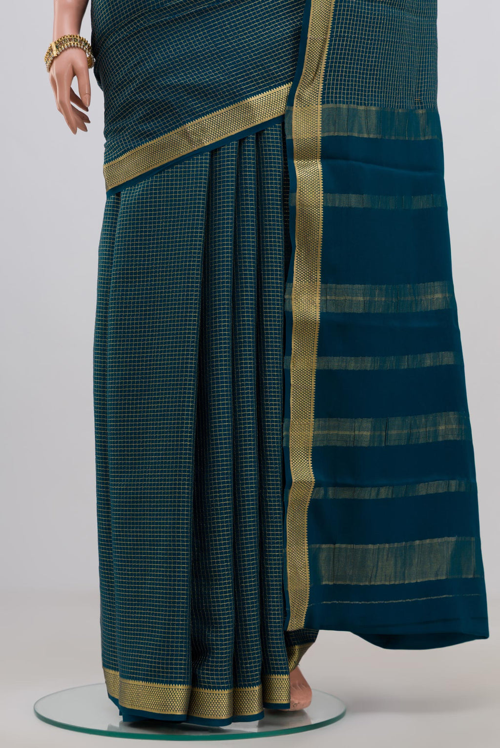Pleats and pallu of Blue Mysore Crepe Saree with Checked design on the body and Zari Border. 