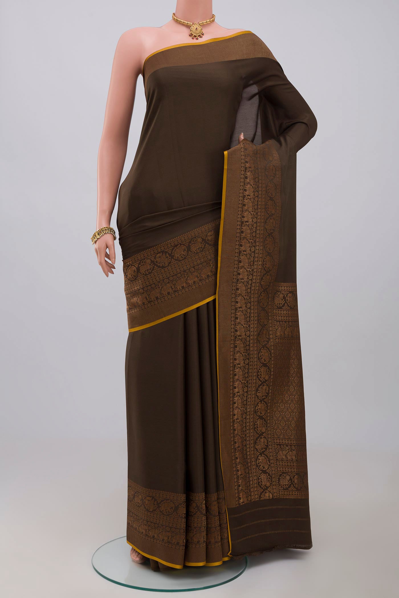Green Crepe Saree with Plain Body and Zari Border.  displayed on a mannequin