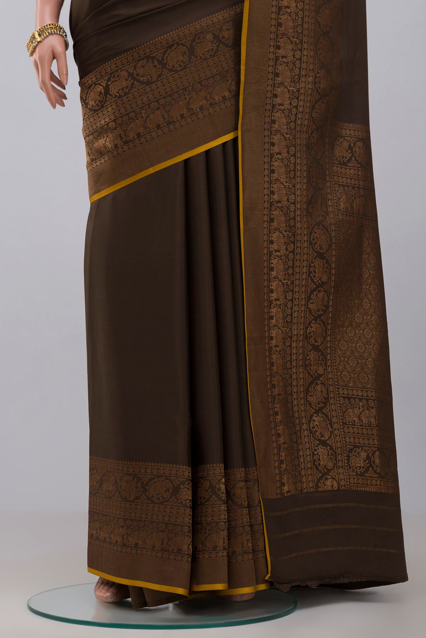 Pleats and pallu of Green Crepe Saree with Plain Body and Zari Border. 