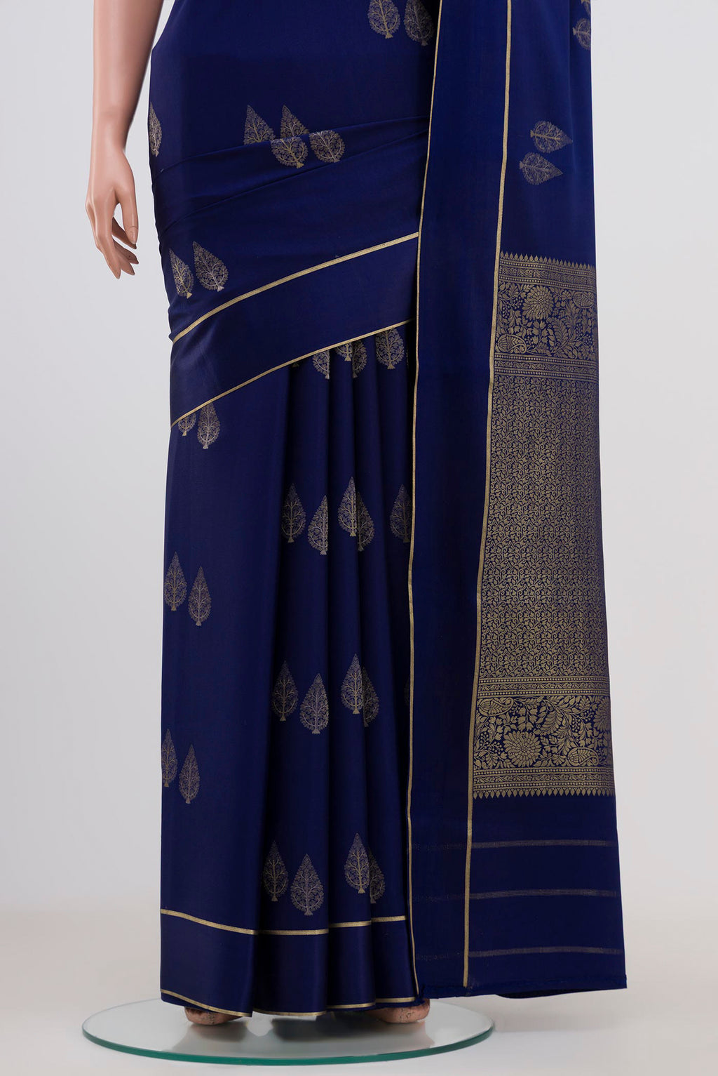 Pleats and pallu of Navy Blue Mysore Crepe Saree with Zari Butta on the body and Thin Zari Line. 