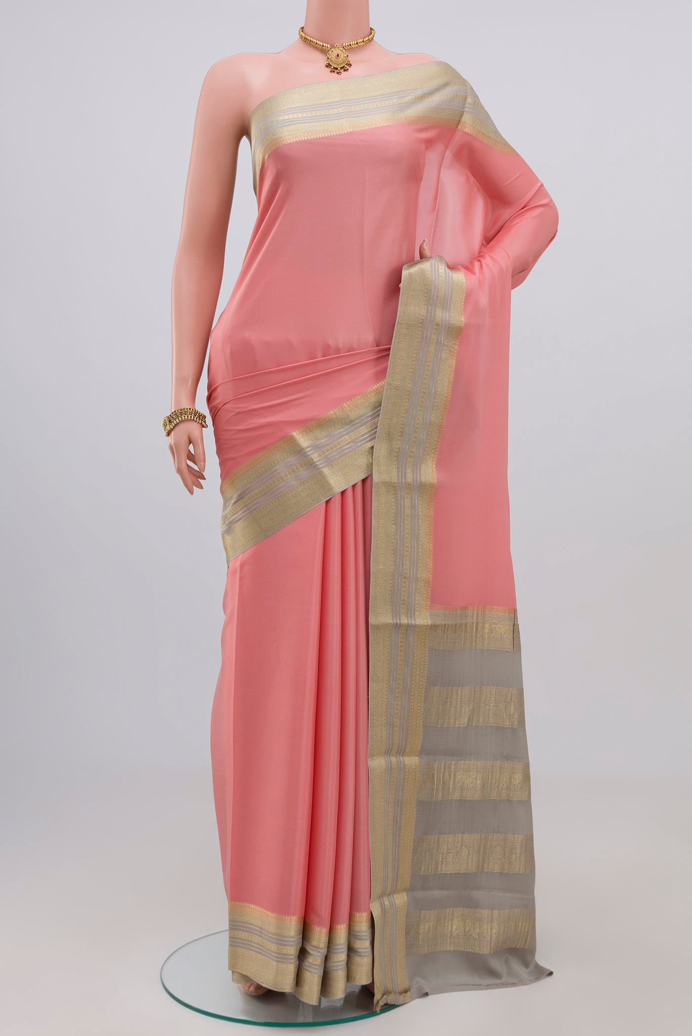 Pink Crepe Saree with Plain Body and Zari Border.  displayed on a mannequin