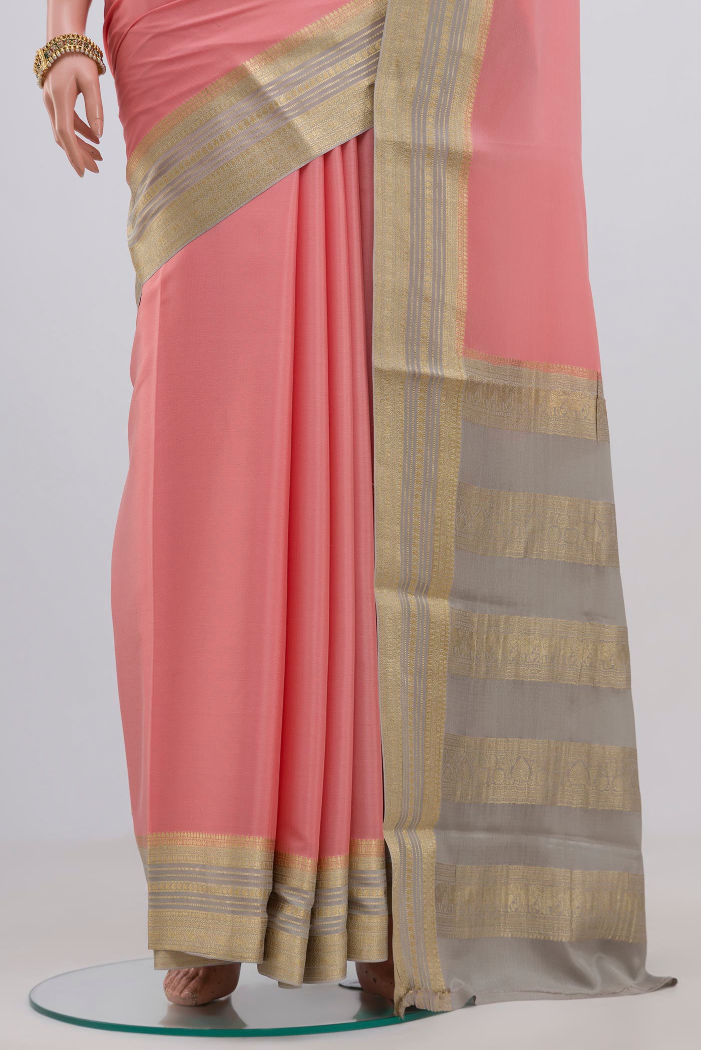 Pleats and pallu of Pink Crepe Saree with Plain Body and Zari Border. 