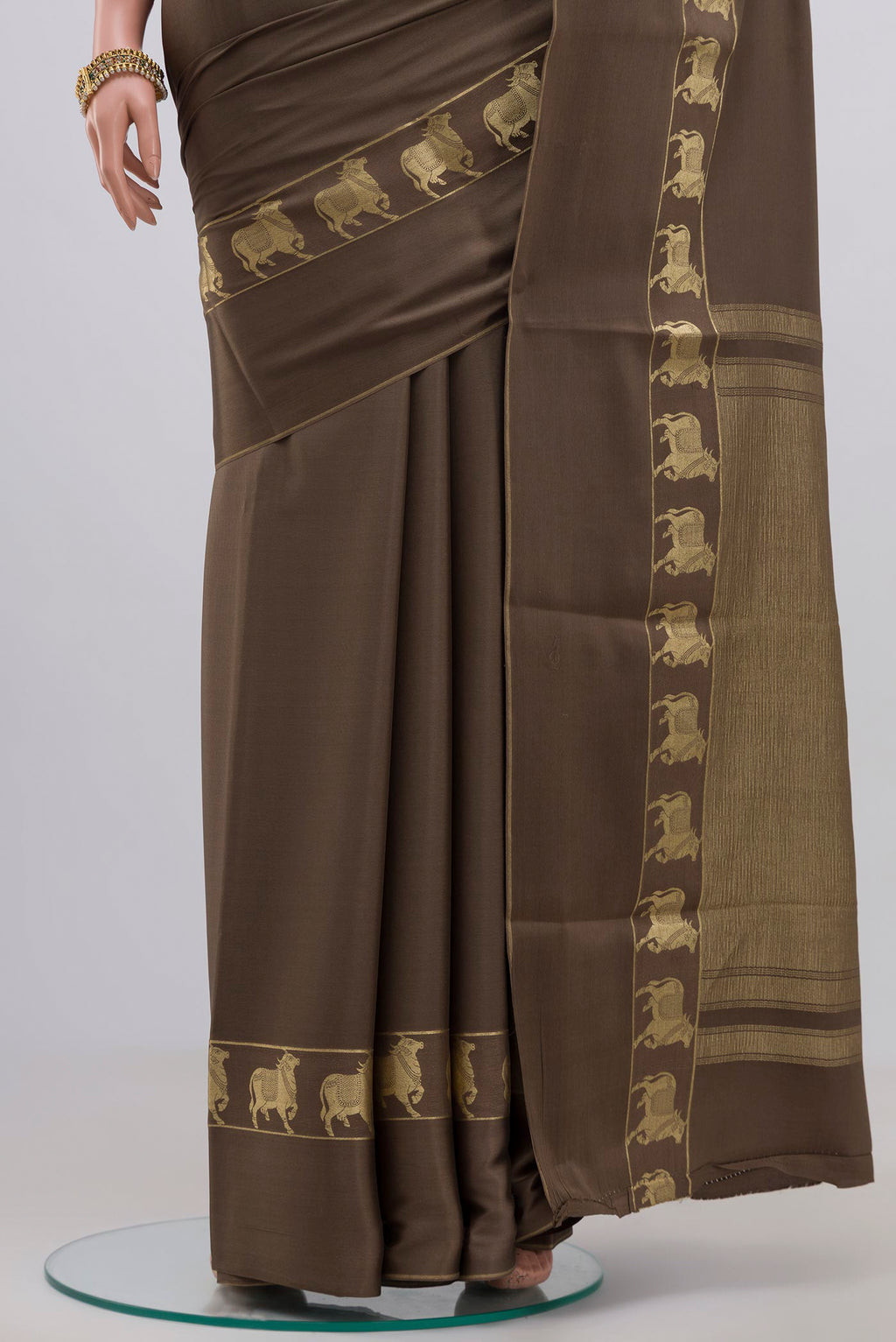 Pleats and pallu of Grey Crepe Saree with Plain Body and Fancy Border. 