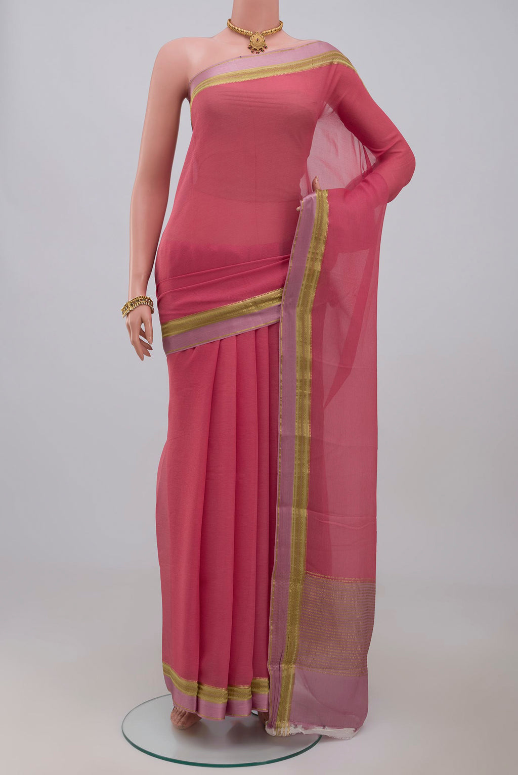 Peach Chiffon Saree with Plain Body and Zari Border.  displayed on a mannequin