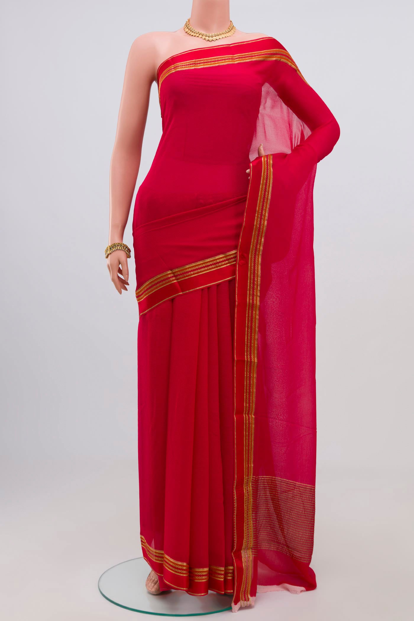 Red Chiffon Saree with Plain Body and Zari Border.  displayed on a mannequin
