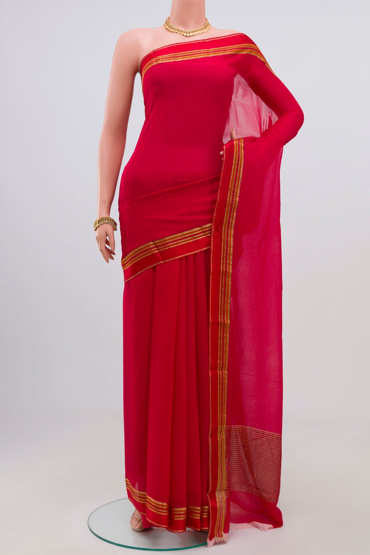Red Chiffon Saree with Plain Body and Zari Border.  displayed on a mannequin