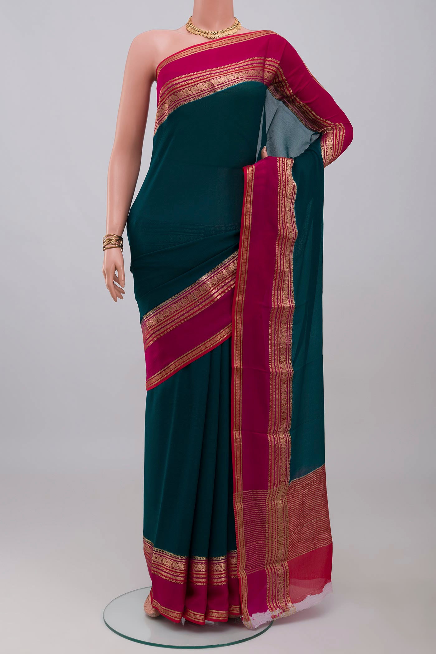 Teal Mysore Chiffon Saree with Plain Body and Zari Border.  displayed on a mannequin