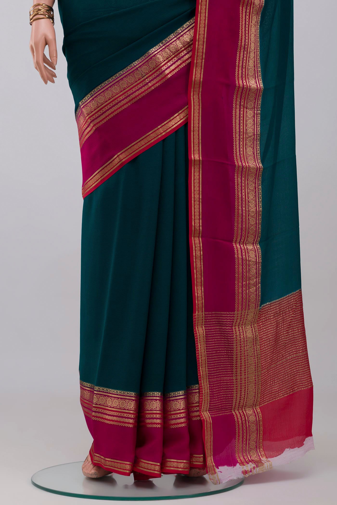 Pleats and pallu of Teal Mysore Chiffon Saree with Plain Body and Zari Border. 