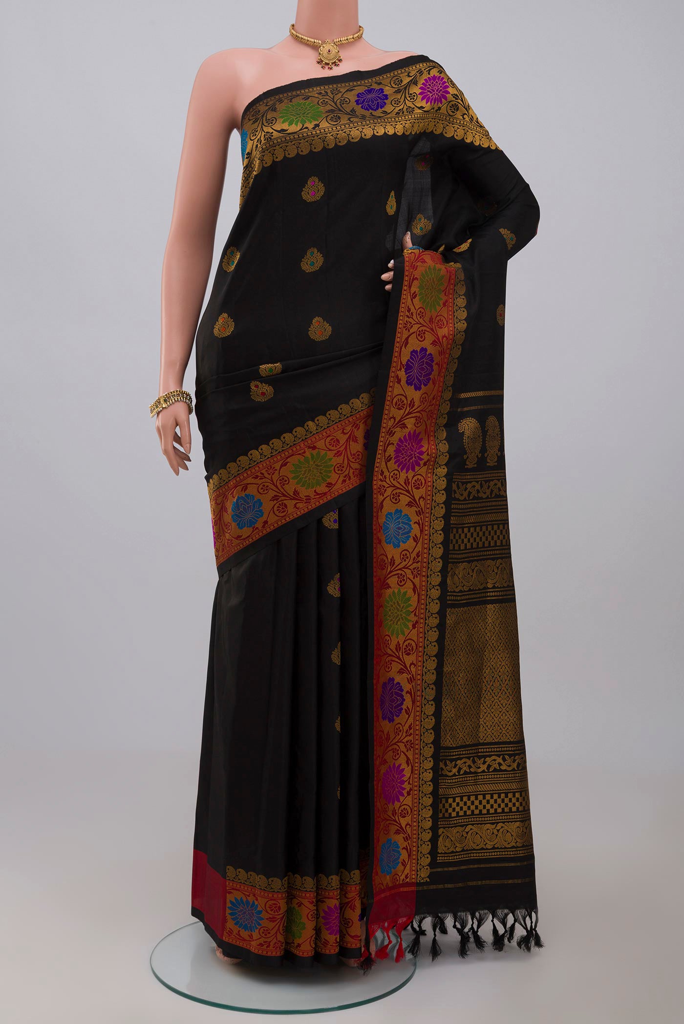 Black Gadwal Silk Saree with Zari Butta on the body and Zari Border.  displayed on a mannequin
