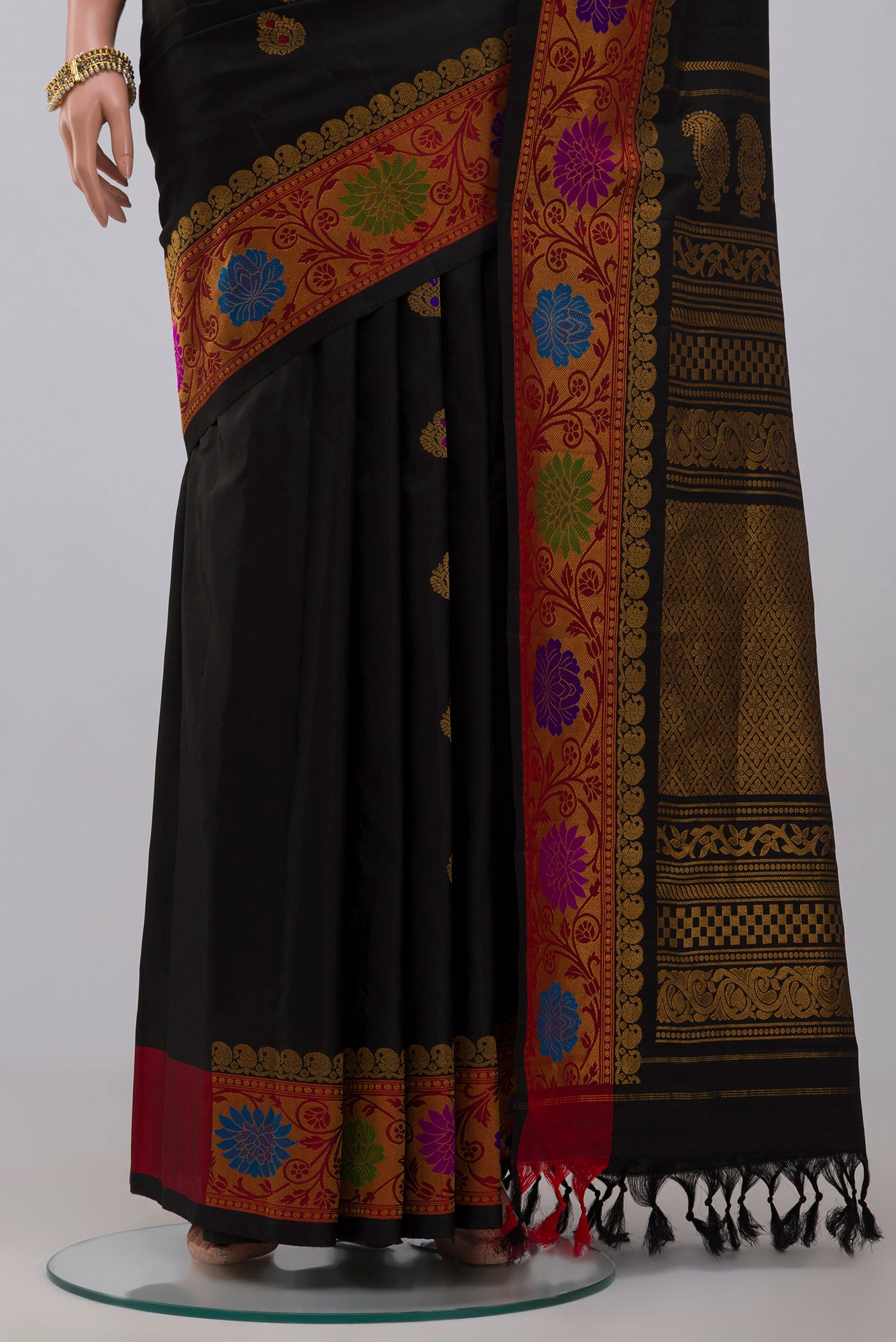 Pleats and pallu of Black Gadwal Silk Saree with Zari Butta on the body and Zari Border. 