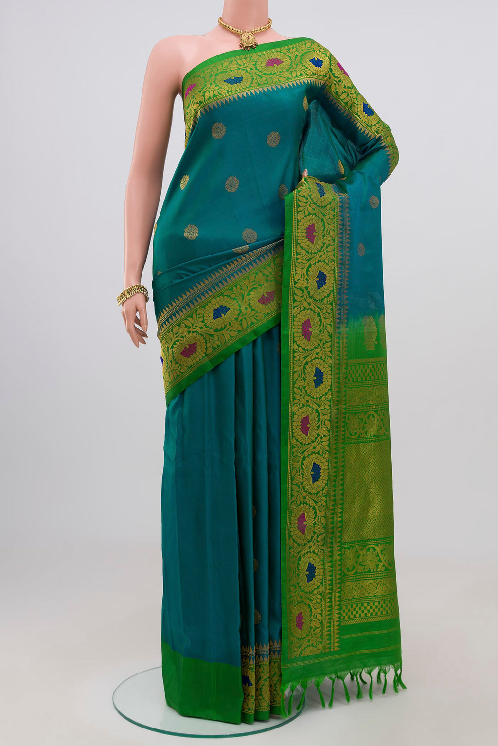 Peacock Blue Gadwal Silk Saree with Zari Butta on the body and Zari Border.  displayed on a mannequin