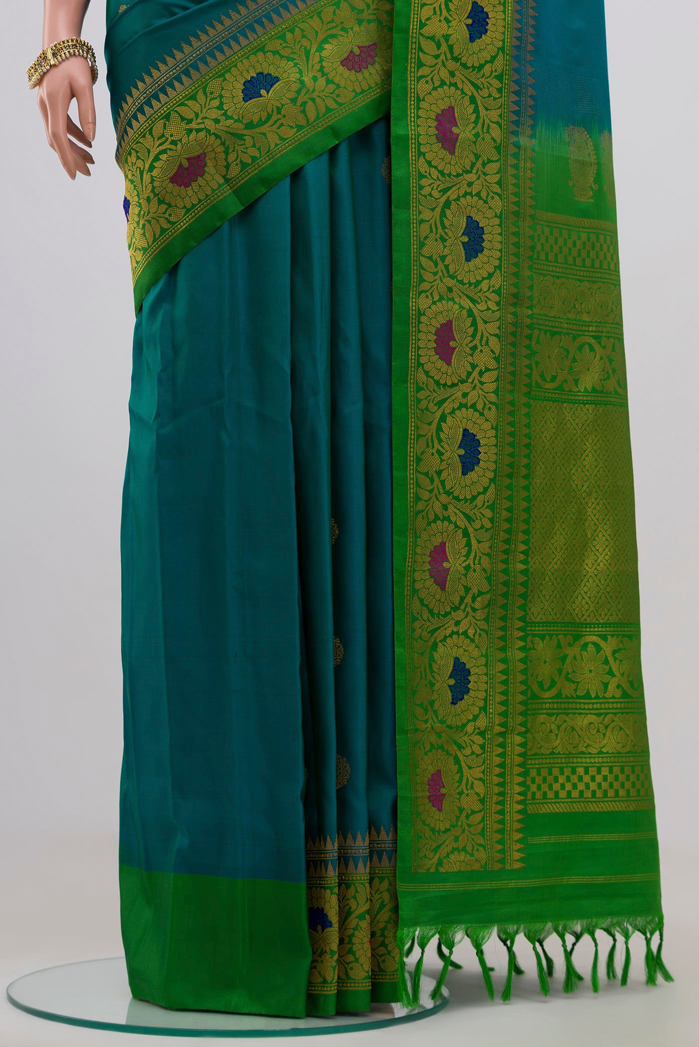 Pleats and pallu of Peacock Blue Gadwal Silk Saree with Zari Butta on the body and Zari Border. 
