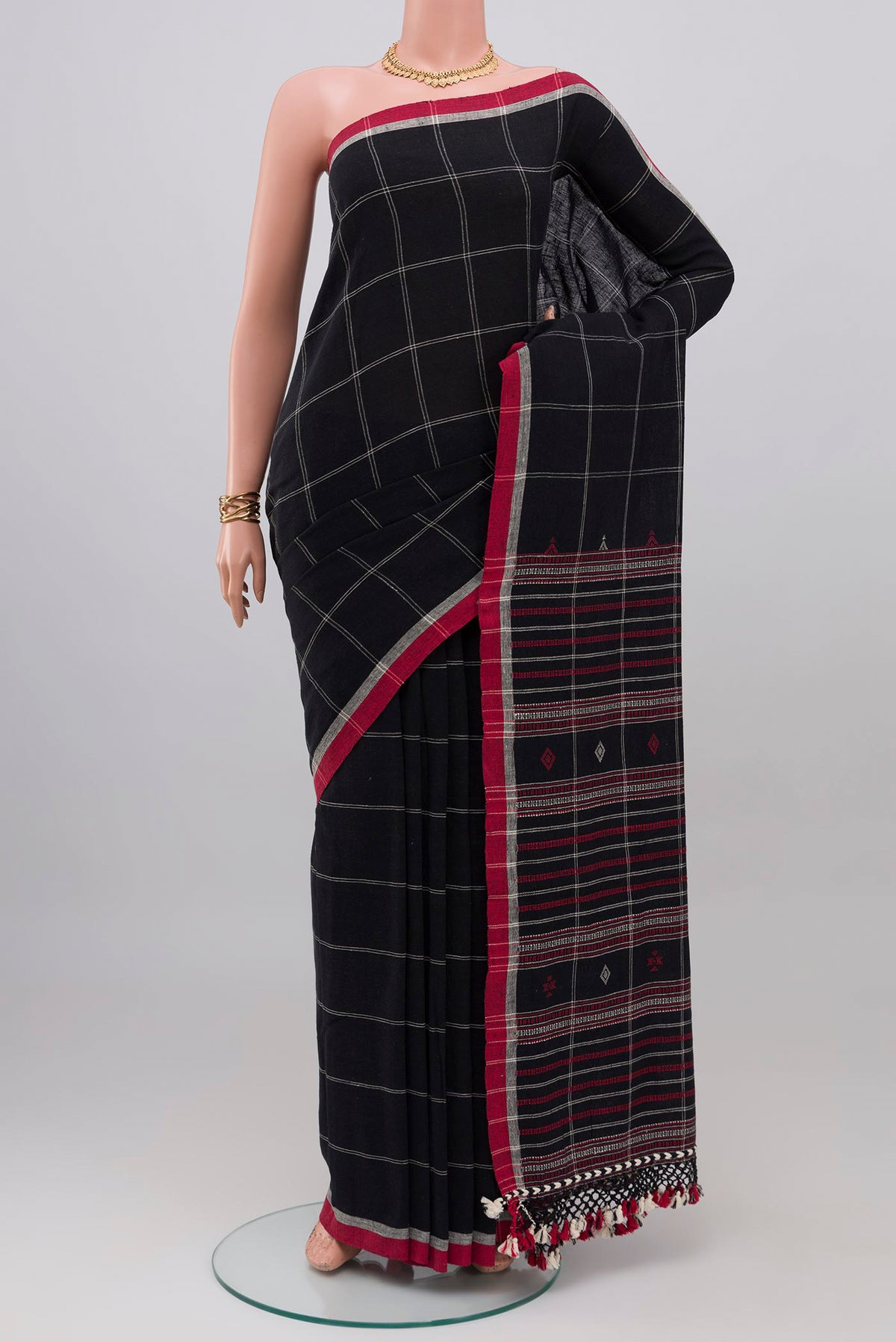 Black Cotton Saree with Checked design on the body and Thread Border.  displayed on a mannequin