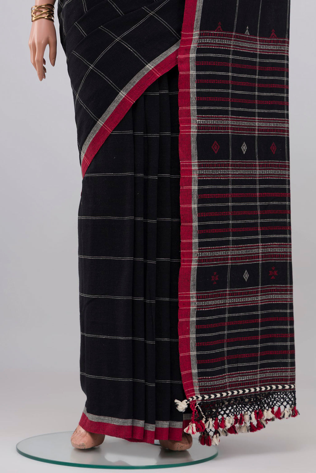Pleats and pallu of Black Cotton Saree with Checked design on the body and Thread Border. 