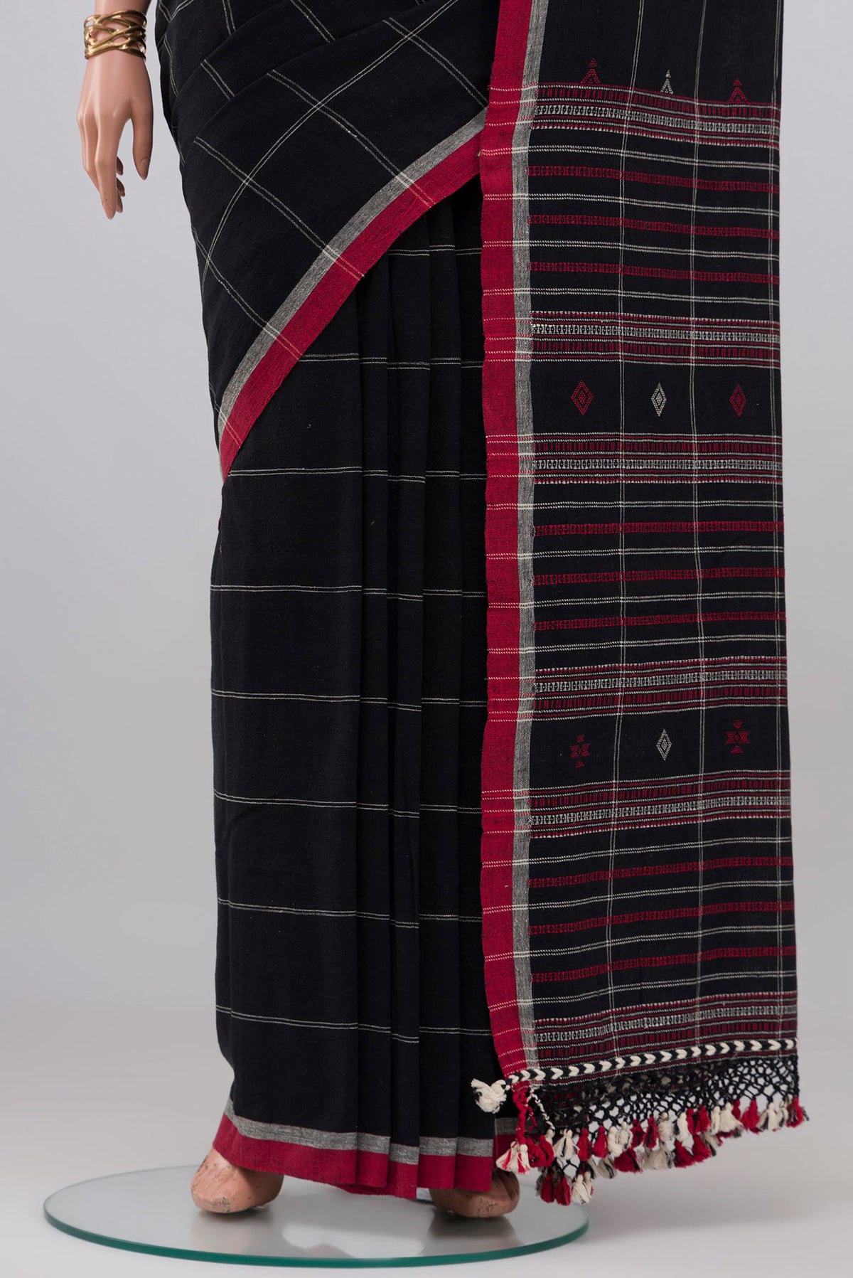Pleats and pallu of Black Cotton Saree with Checked design on the body and Thread Border. 