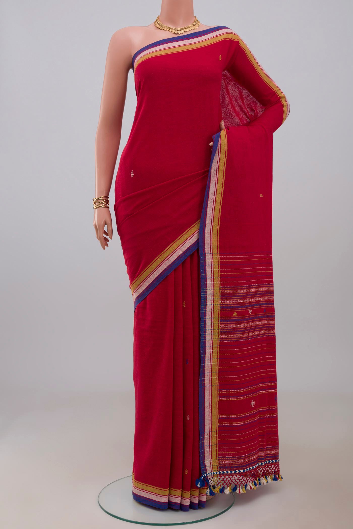 Red Assam Cotton Saree with Thread Butta on the body and Thread Border.  displayed on a mannequin