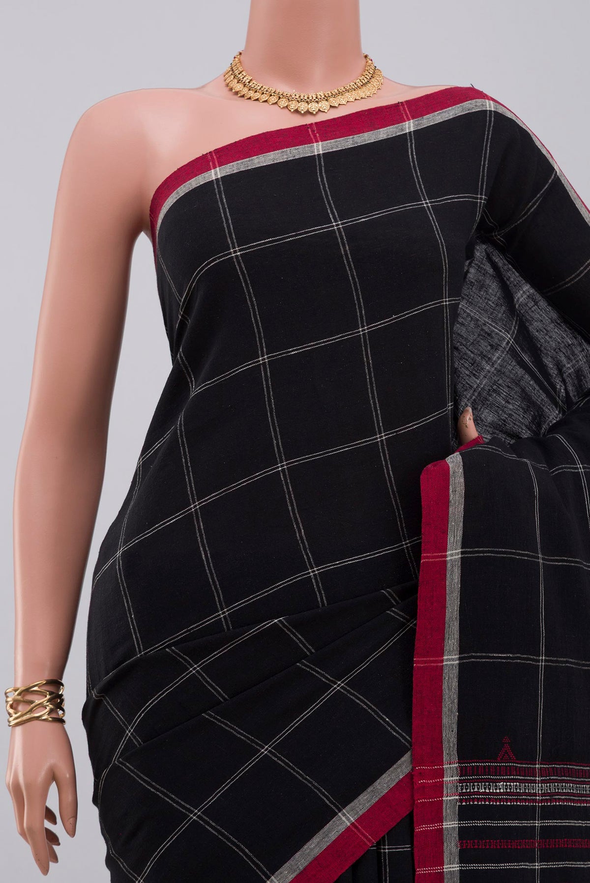 Border image of Black Assam Cotton Saree with Checked design on the body and Thread Border. 