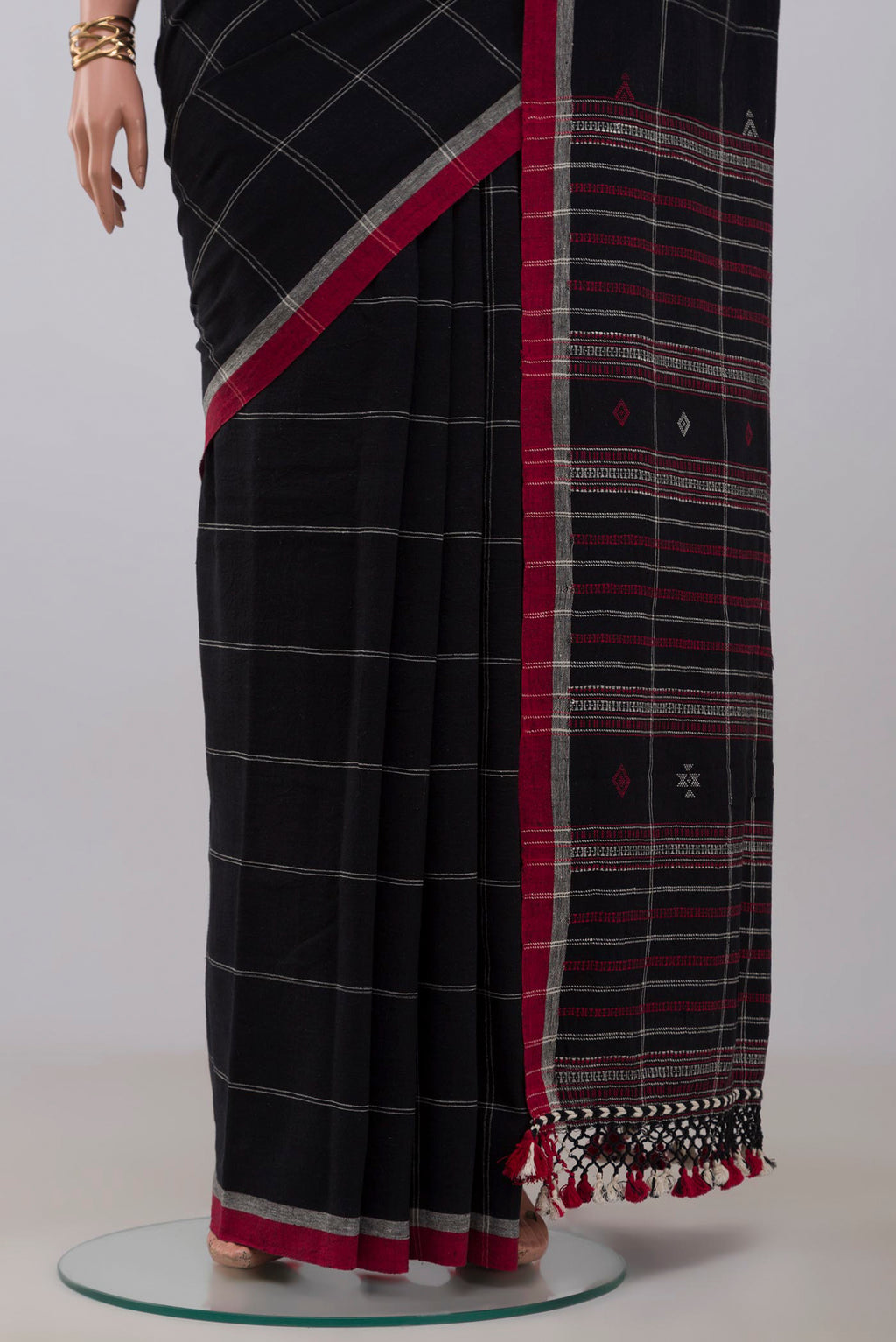 Pleats and pallu of Black Assam Cotton Saree with Checked design on the body and Thread Border. 