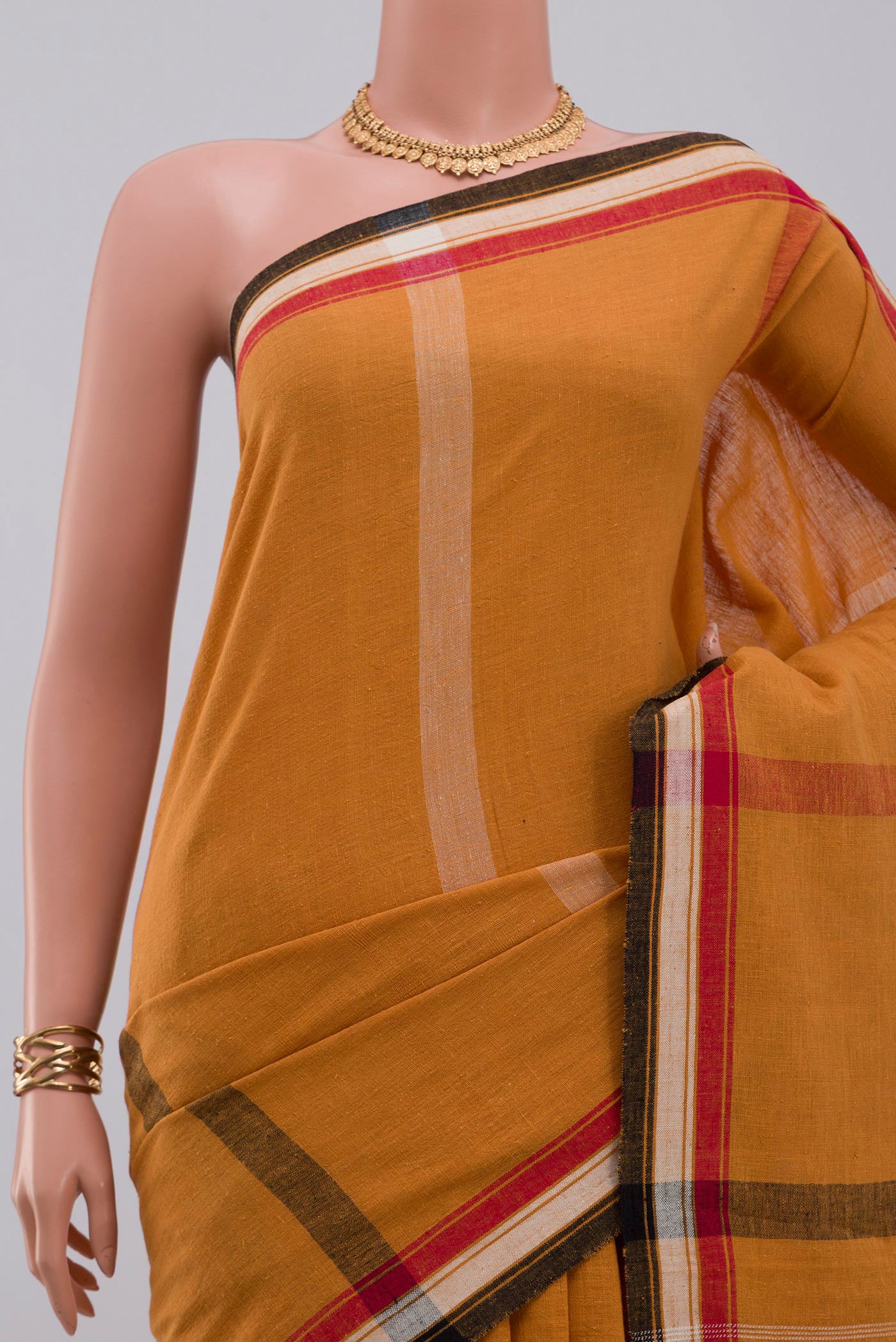 Border image of Yellow Assam Cotton Saree with Plain Body and Thread Border. 
