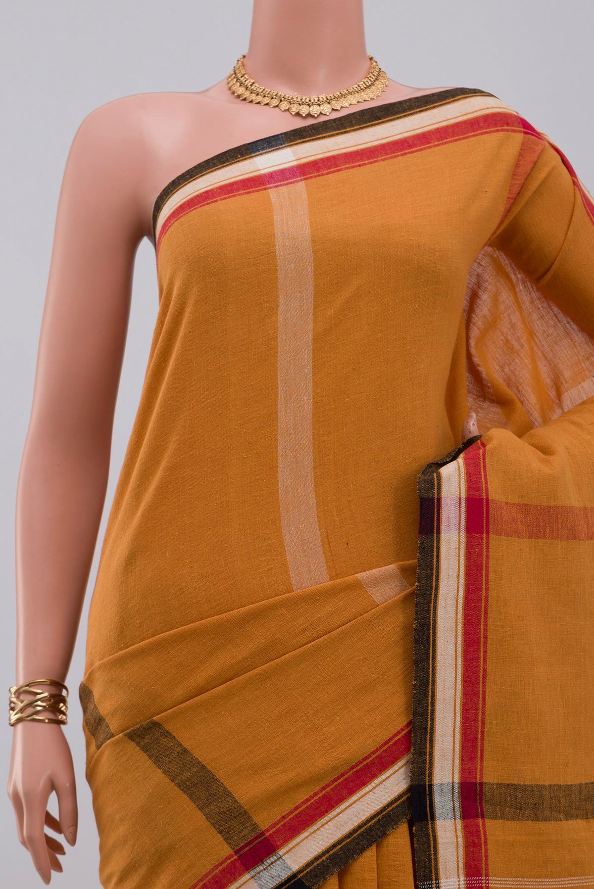 Border image of Yellow Assam Cotton Saree with Plain Body and Thread Border. 