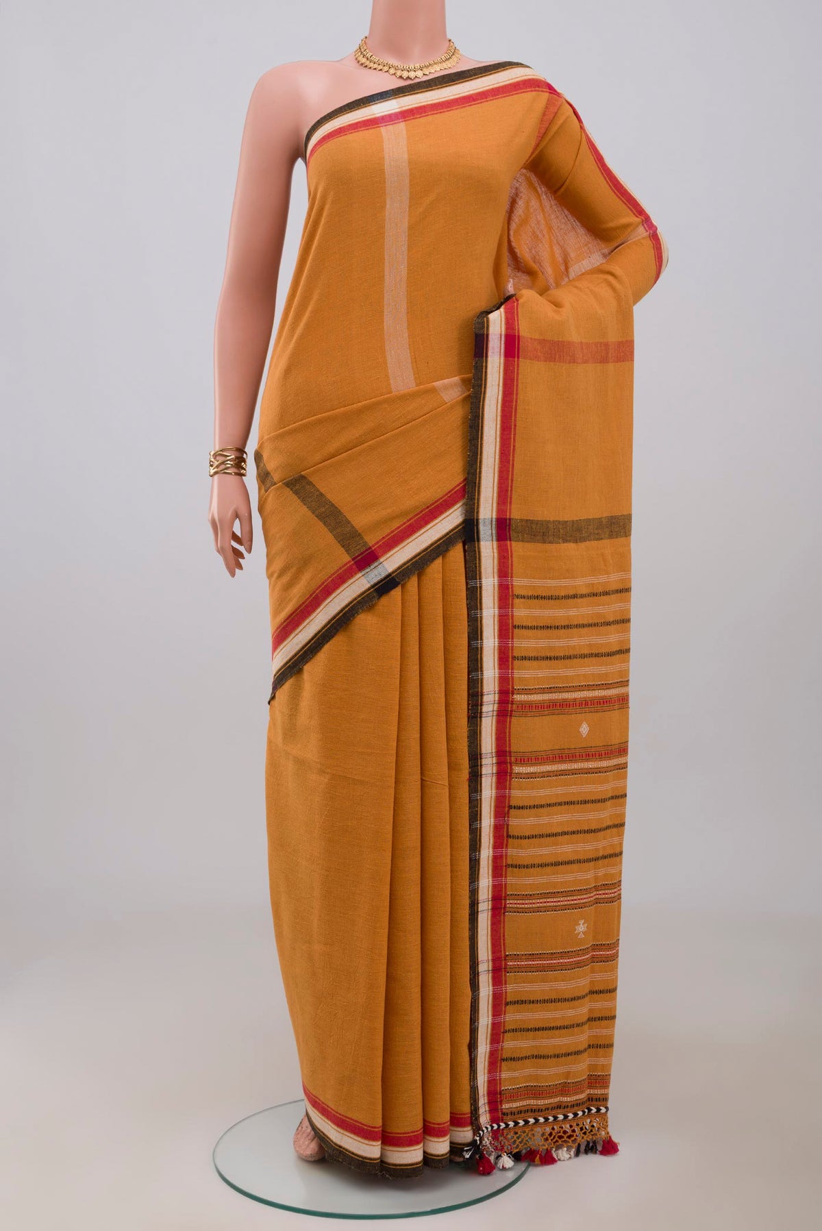 Yellow Assam Cotton Saree with Plain Body and Thread Border.  displayed on a mannequin