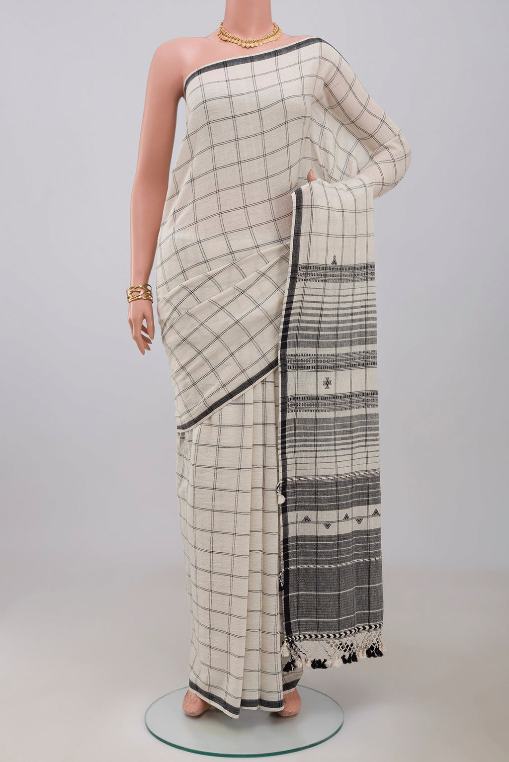 White Bengal Cotton Saree with Checked design on the body and Plain Border.  displayed on a mannequin
