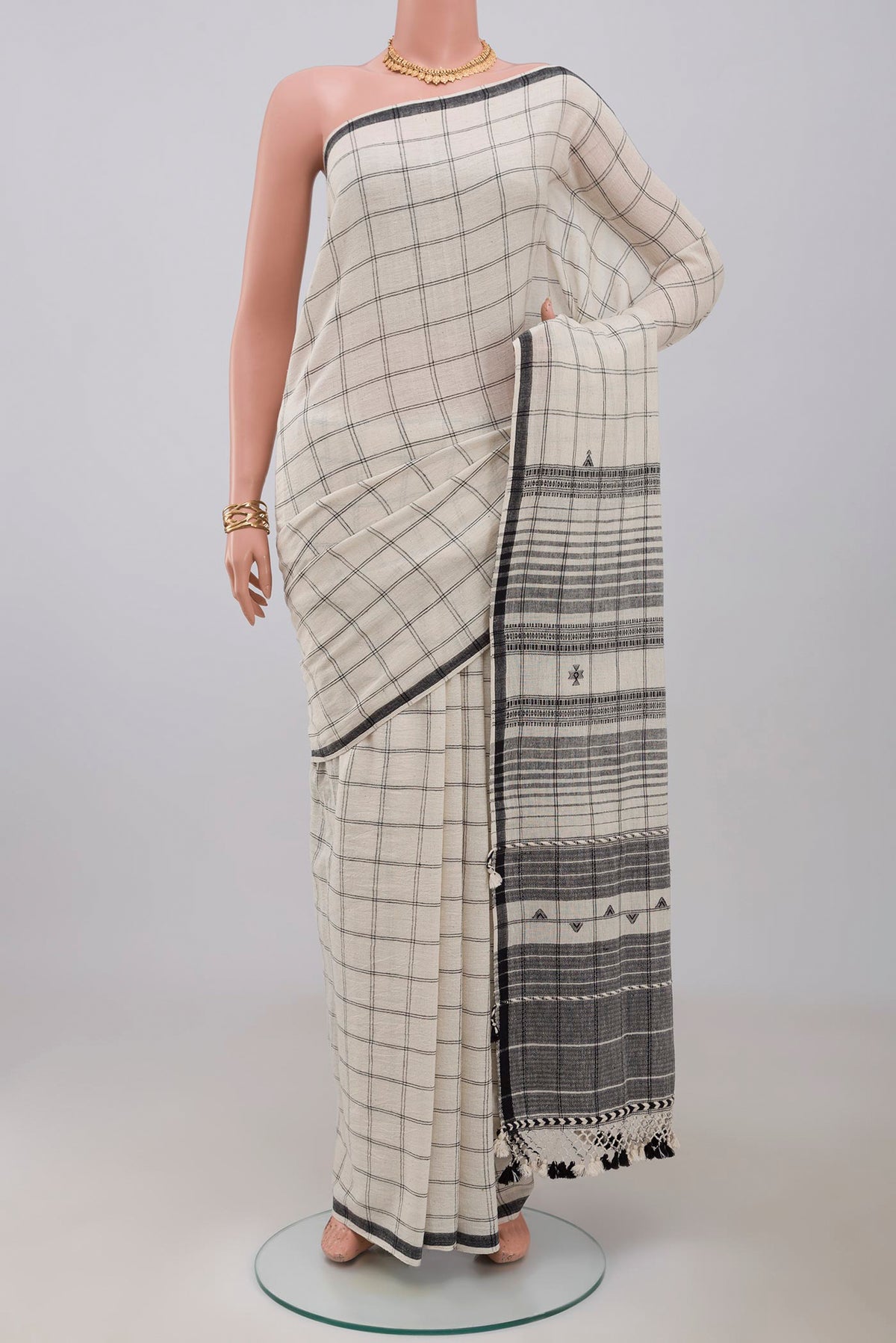 White Bengal Cotton Saree with Checked design on the body and Plain Border.  displayed on a mannequin