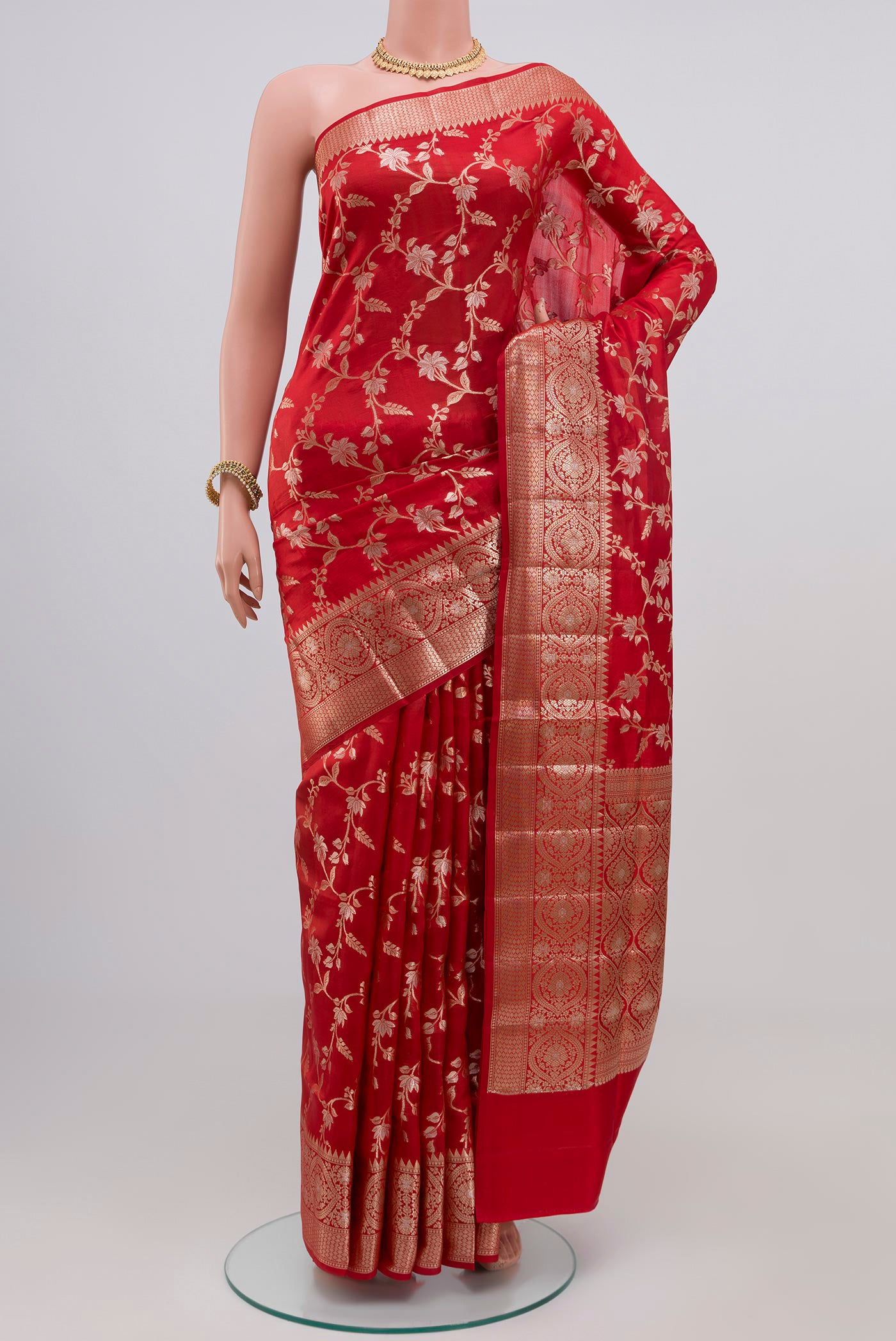 Red Raw Silk Saree with Zari Butta on the body and Zari Border.  displayed on a mannequin