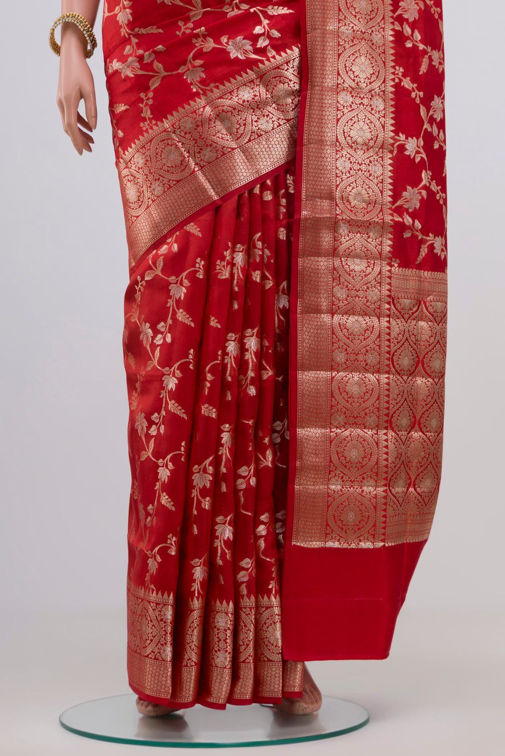 Pleats and pallu of Red Raw Silk Saree with Zari Butta on the body and Zari Border. 