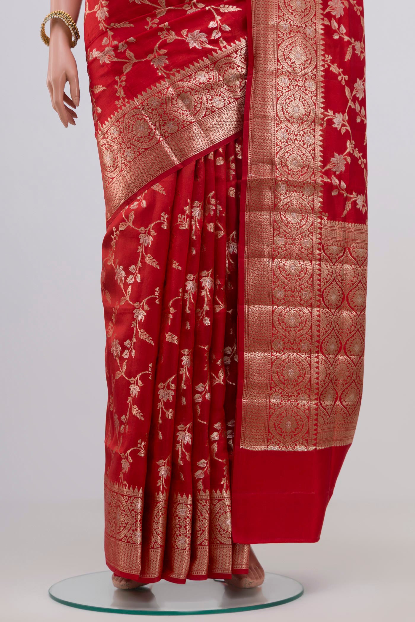 Pleats and pallu of Red Raw Silk Saree with Zari Butta on the body and Zari Border. 