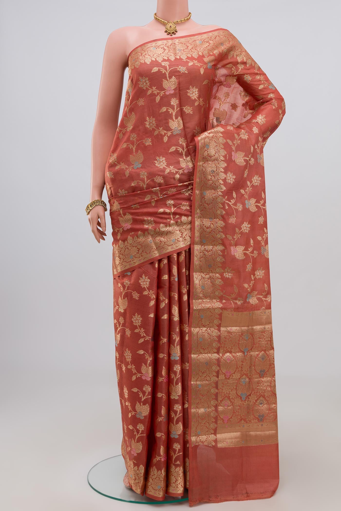 Peach Tussar Silk Saree with Fancy on the body and Zari Border.  displayed on a mannequin