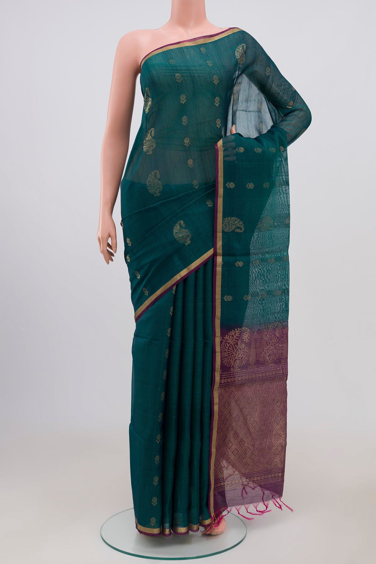 Peacock Blue Silk Cotton Saree with Zari Butta on the body and Thin Zari Line.  displayed on a mannequin
