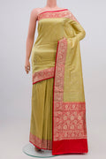 Pista Green Banarasi Katan Silk Saree with Zari Butta on the body and Zari Border.  displayed on a mannequin